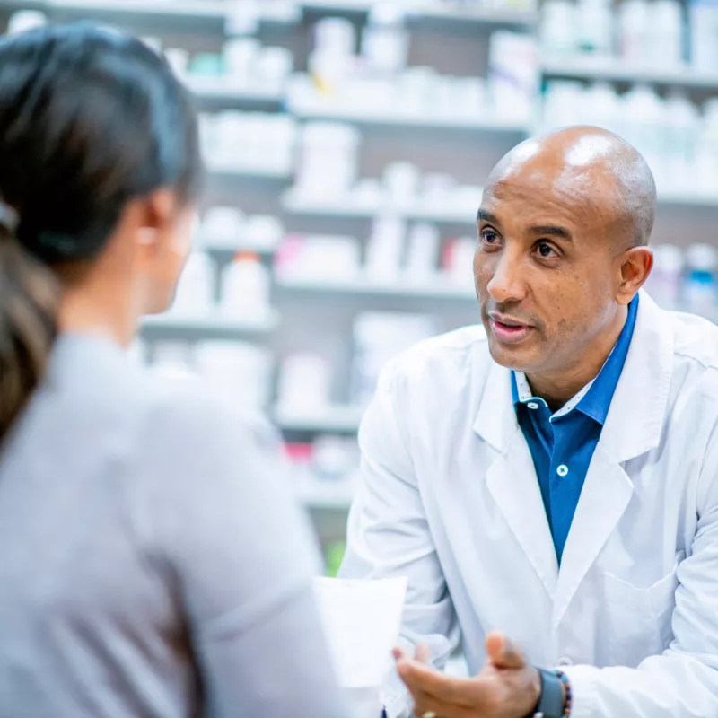 A Pharmacist Speaks to a Patient About Medication