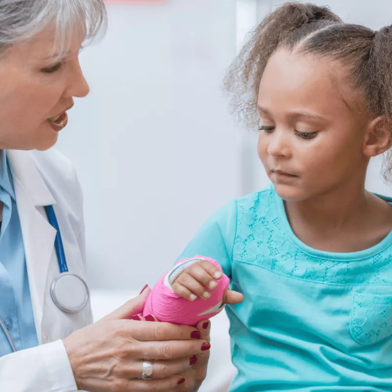A Doctor Check's a Little Girl's New Cast