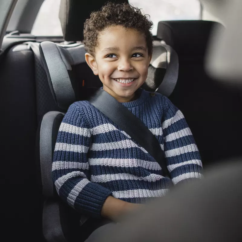 A little boy in a carseat.