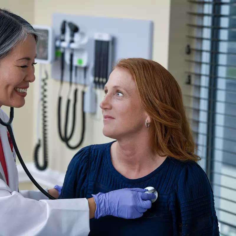 Doctor checking heart beat.