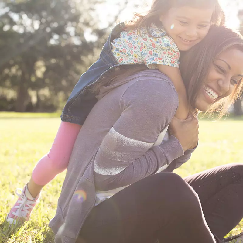 Daughter climbing on her Mother