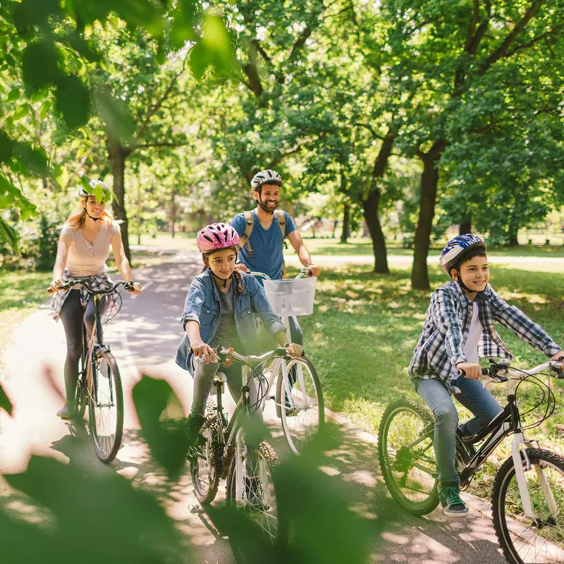 A family on a bike ride at a park