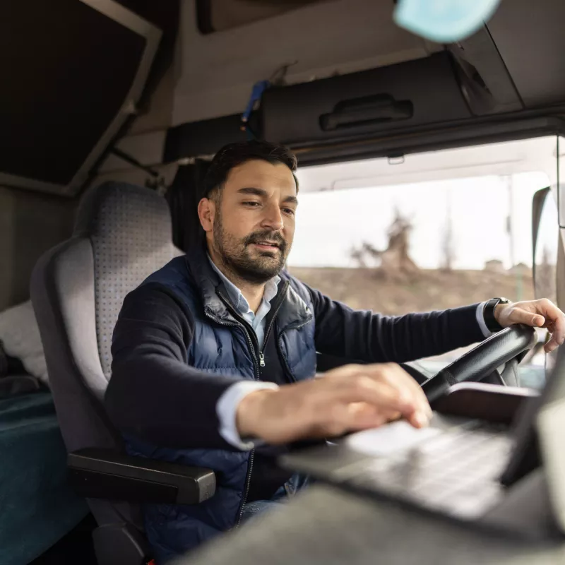A Commercial Driver Check's the Laptop in His Truck