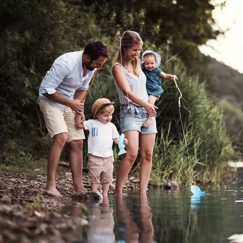 A family standing by the water.