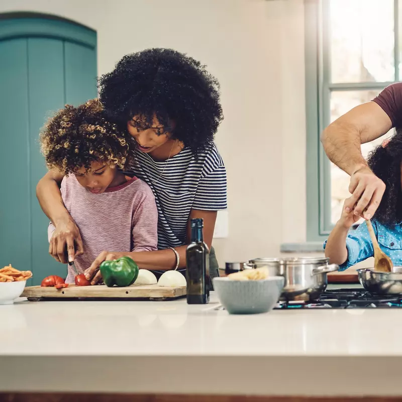 A family cooking a healthy meal together.