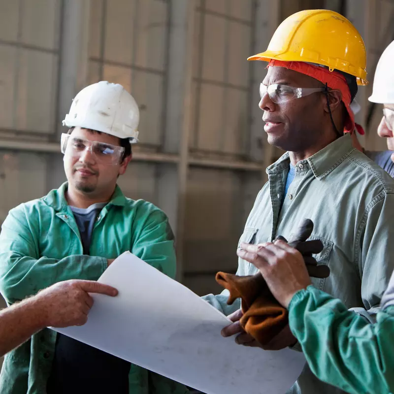 Workers discussing plans