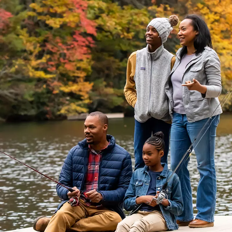 Family fishing by the lake in the Fall.