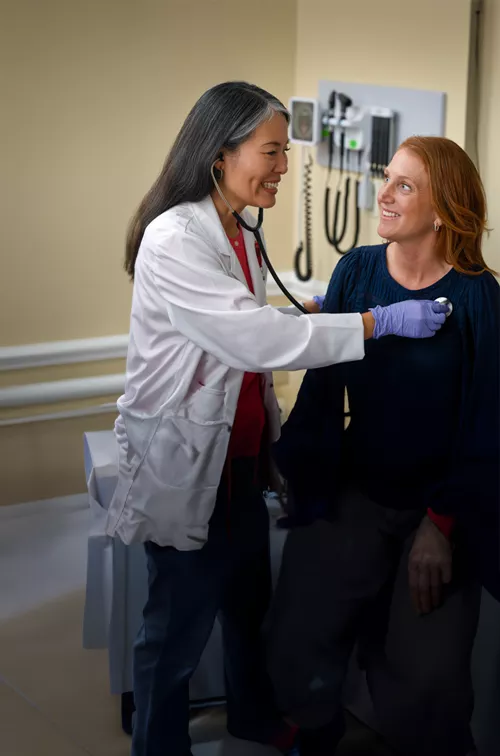 A Provider Checks Her Patient's Vitals in an Exam Room