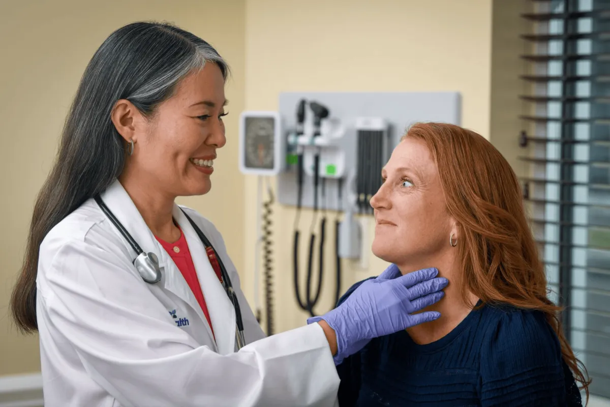 AdventHealth physician checking patient's throat