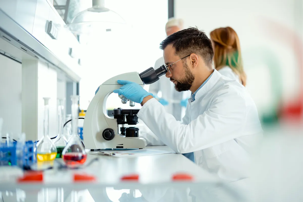 Scientist looking in microscope