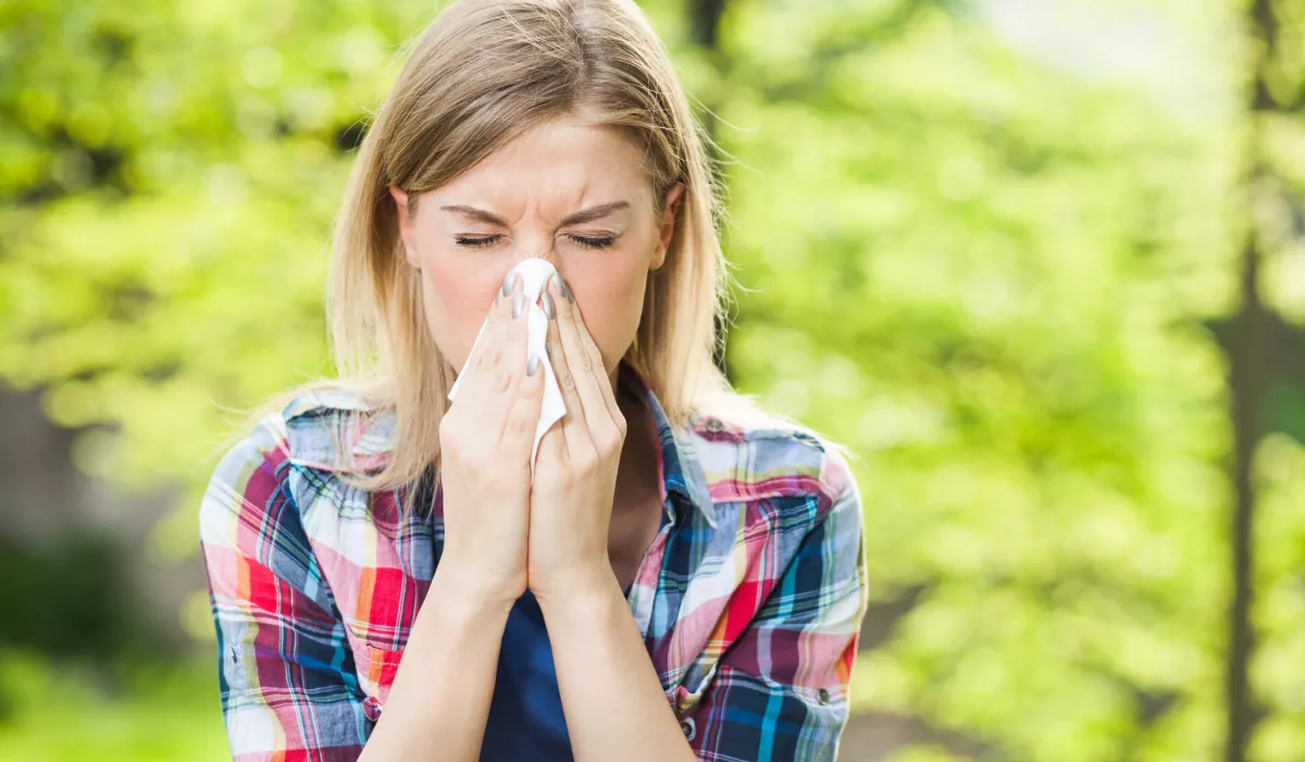 Woman Sneezing Outdoors